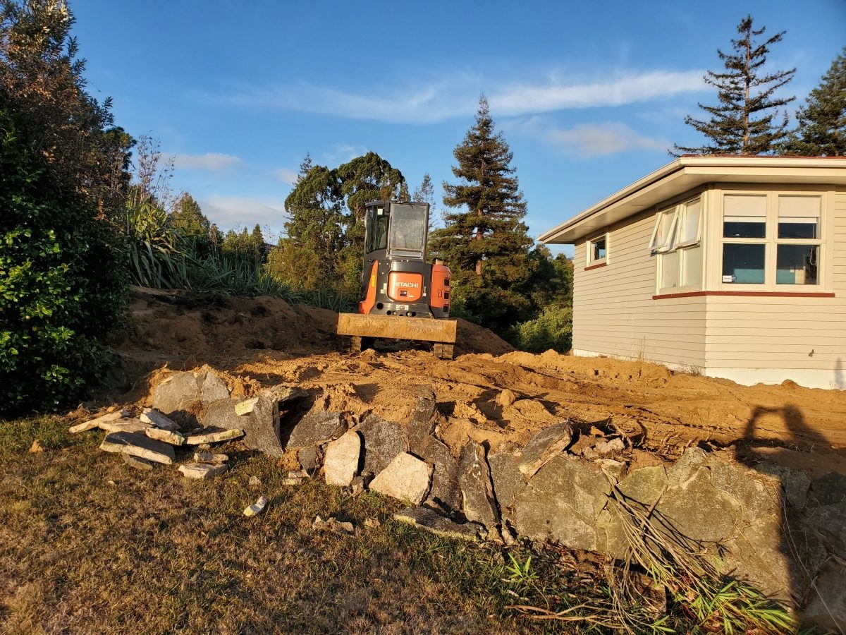 Bank cut against retaining wall line